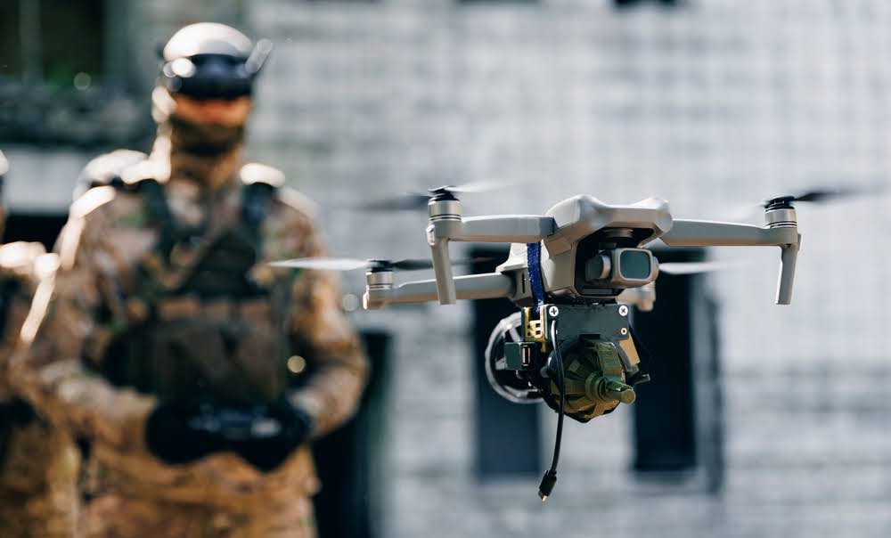 military drone with a blurred operator in the background