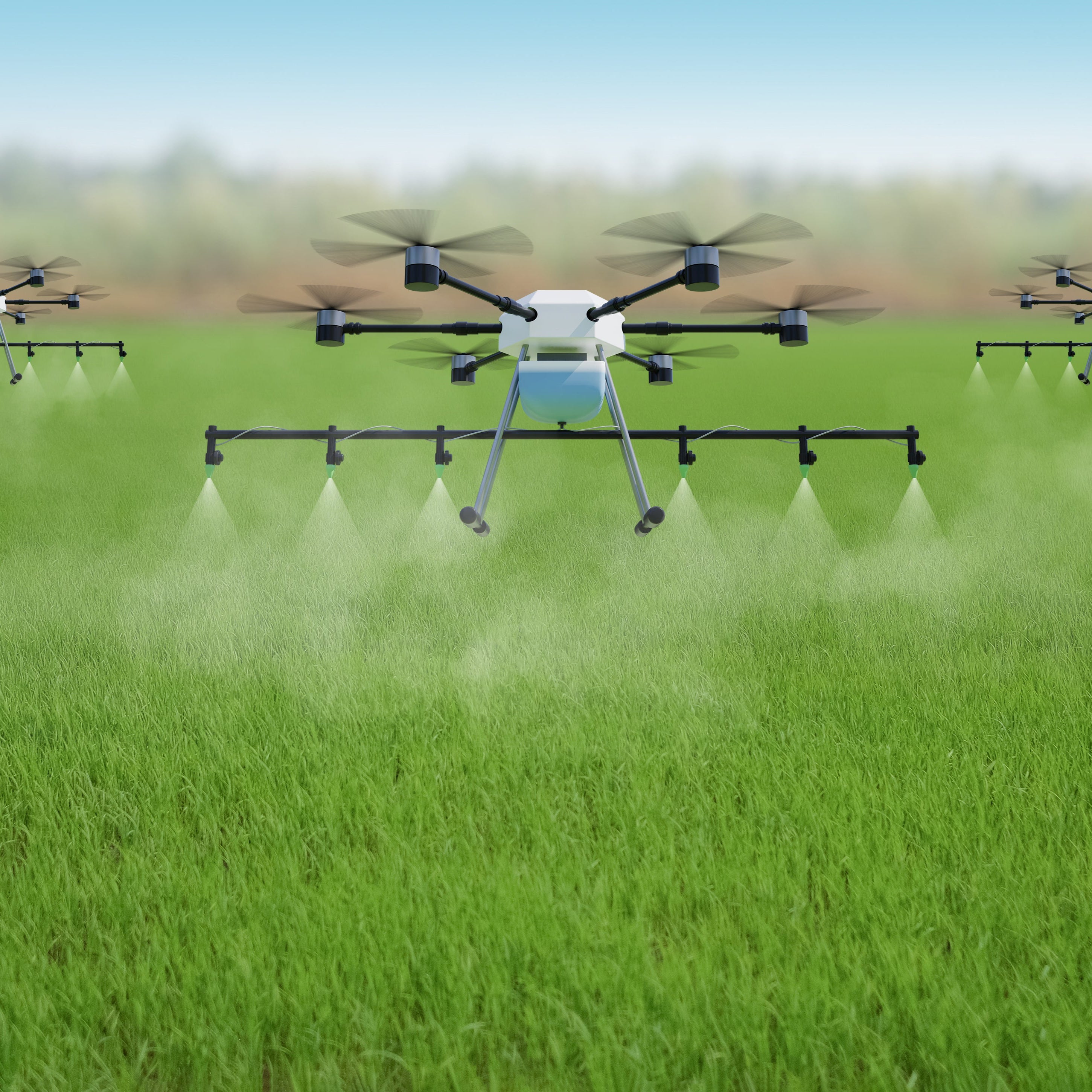 agriculture drones misting a field