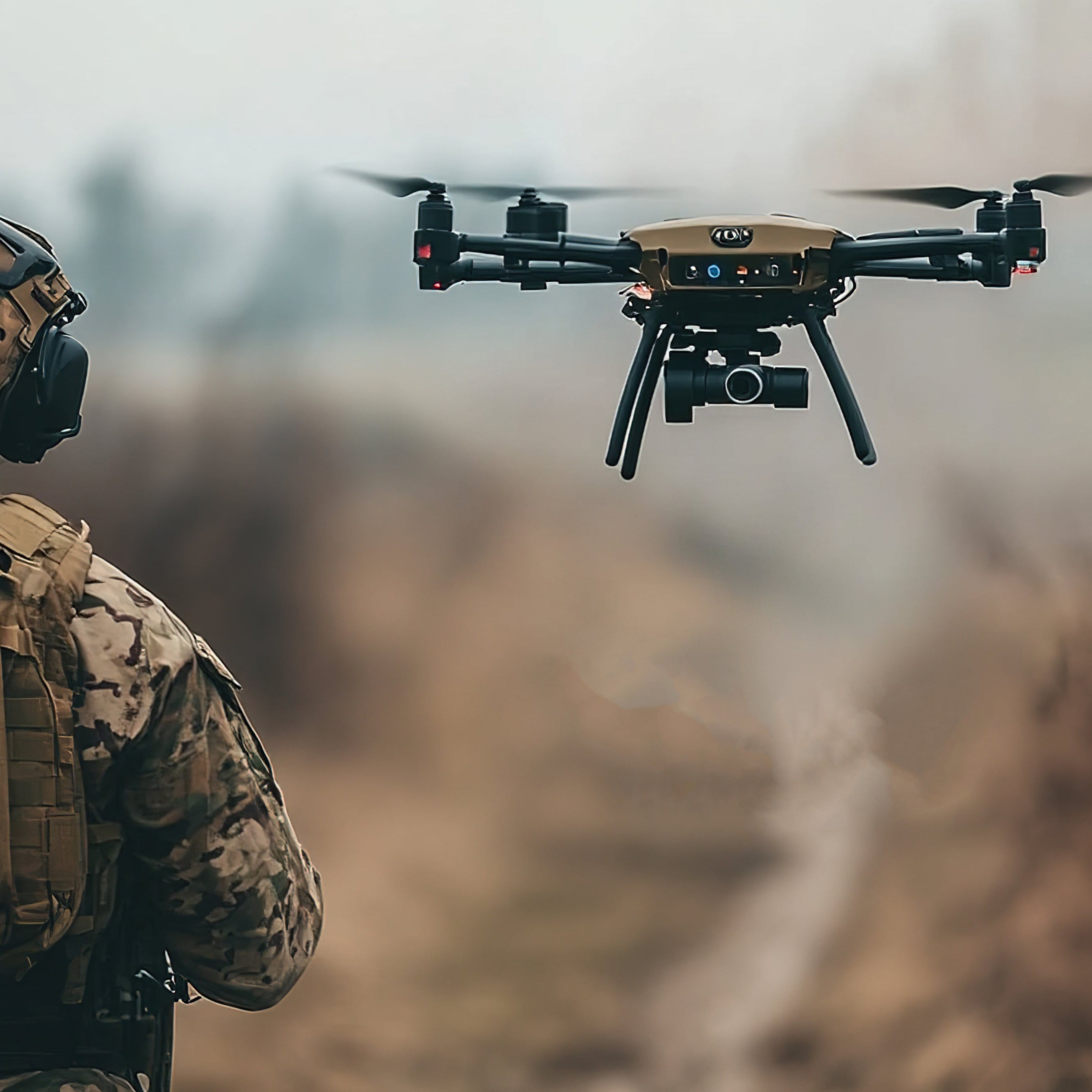 military uav with pilot off to the left in the forefront
